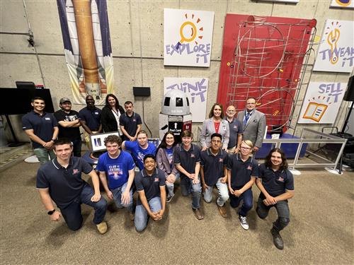 group pic of construction academy students from Bob Jones by the postbox they designed at the U.S. Space and Rocket Center.